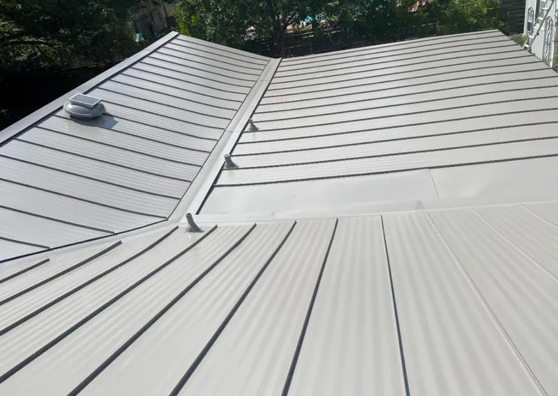 Solar attic fan installed on a metal roof for Roof Ventilation in Houlton